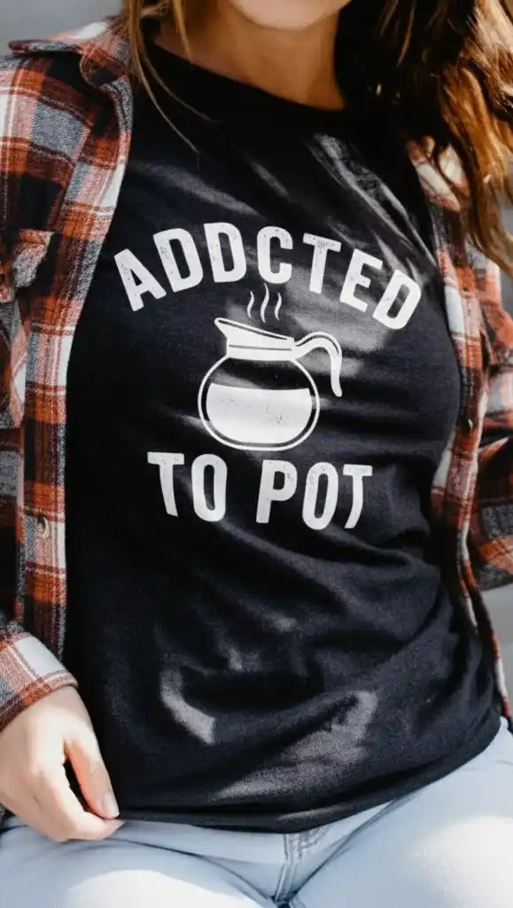 Woman wearing a funny coffee t-shirt that says ‘Addicted to Pot’ from Sip & Shirt – printed in the USA.